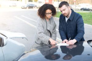 two people talking after a car accident